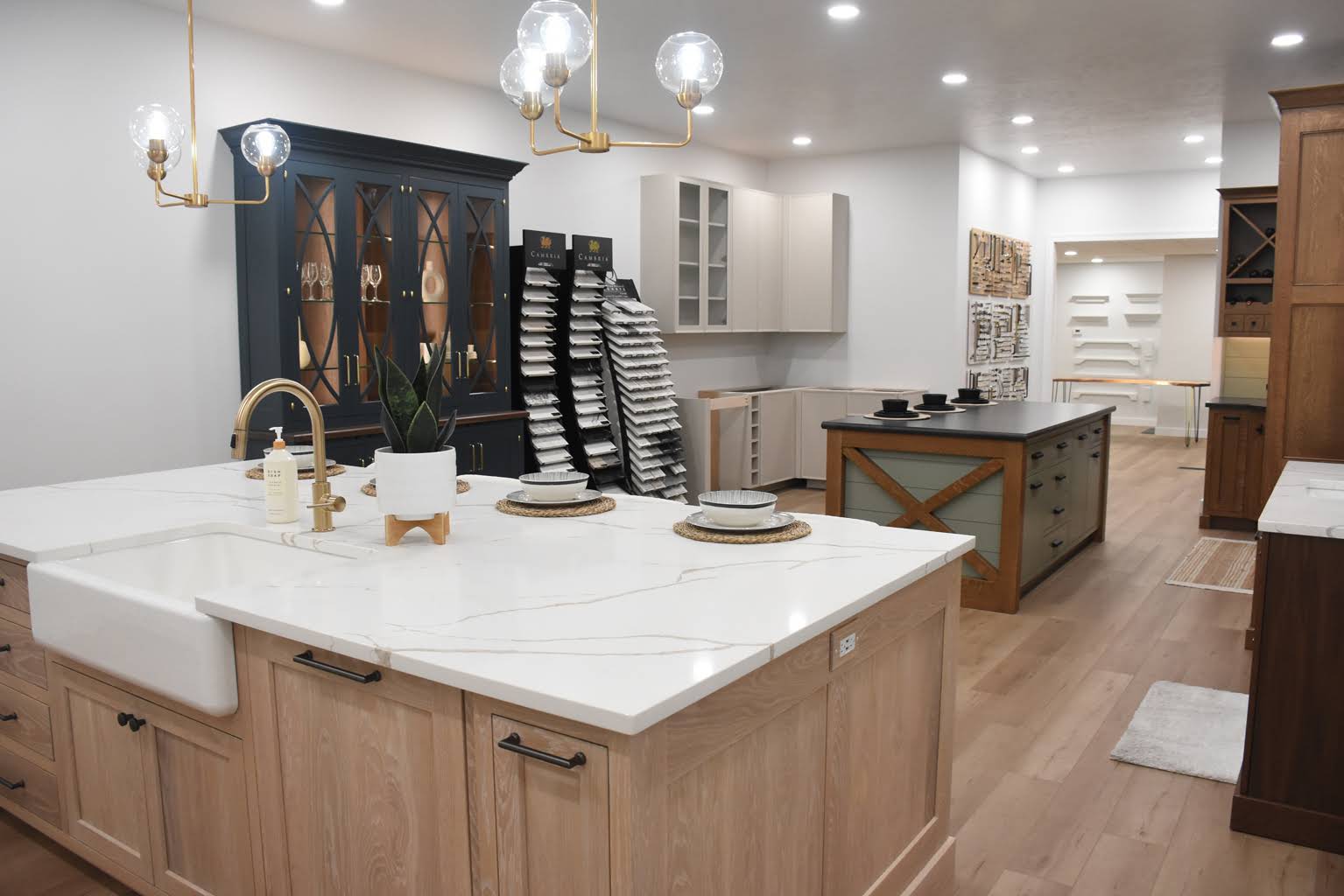 Natural wood island and bright cabinetry in the Elite Kitchens showroom